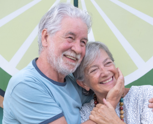 Smiling elderly couple, Diamond and her husband, celebrating credit repair success