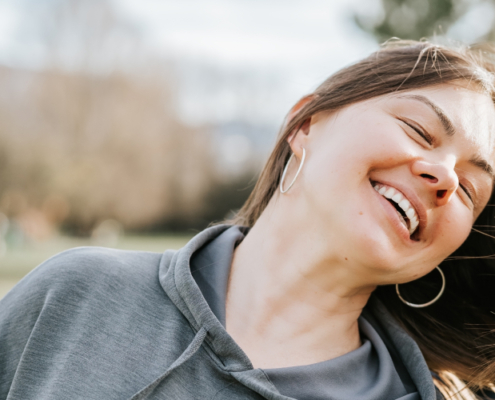 Happy woman enjoying outdoors, representing credit repair success story